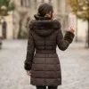 Дамско елегантно дълго зимно яке в тъмнокафяв цвят с богата пух на качулката, кожени детайли и колан-2099
